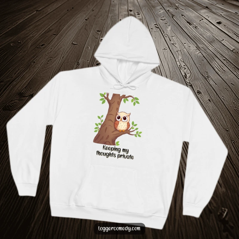 Funny shy owl hoodie with a cute, observing owl character nestled in a tree by logs, offering warmth and humor.